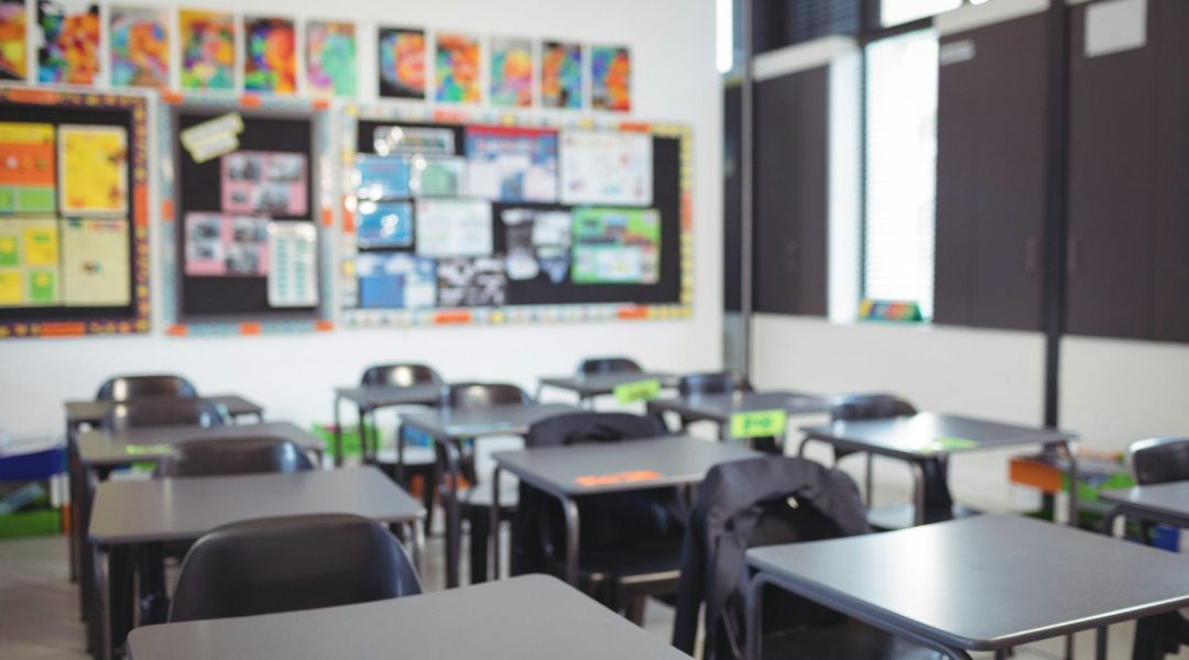 Empty classroom with desks and chairs